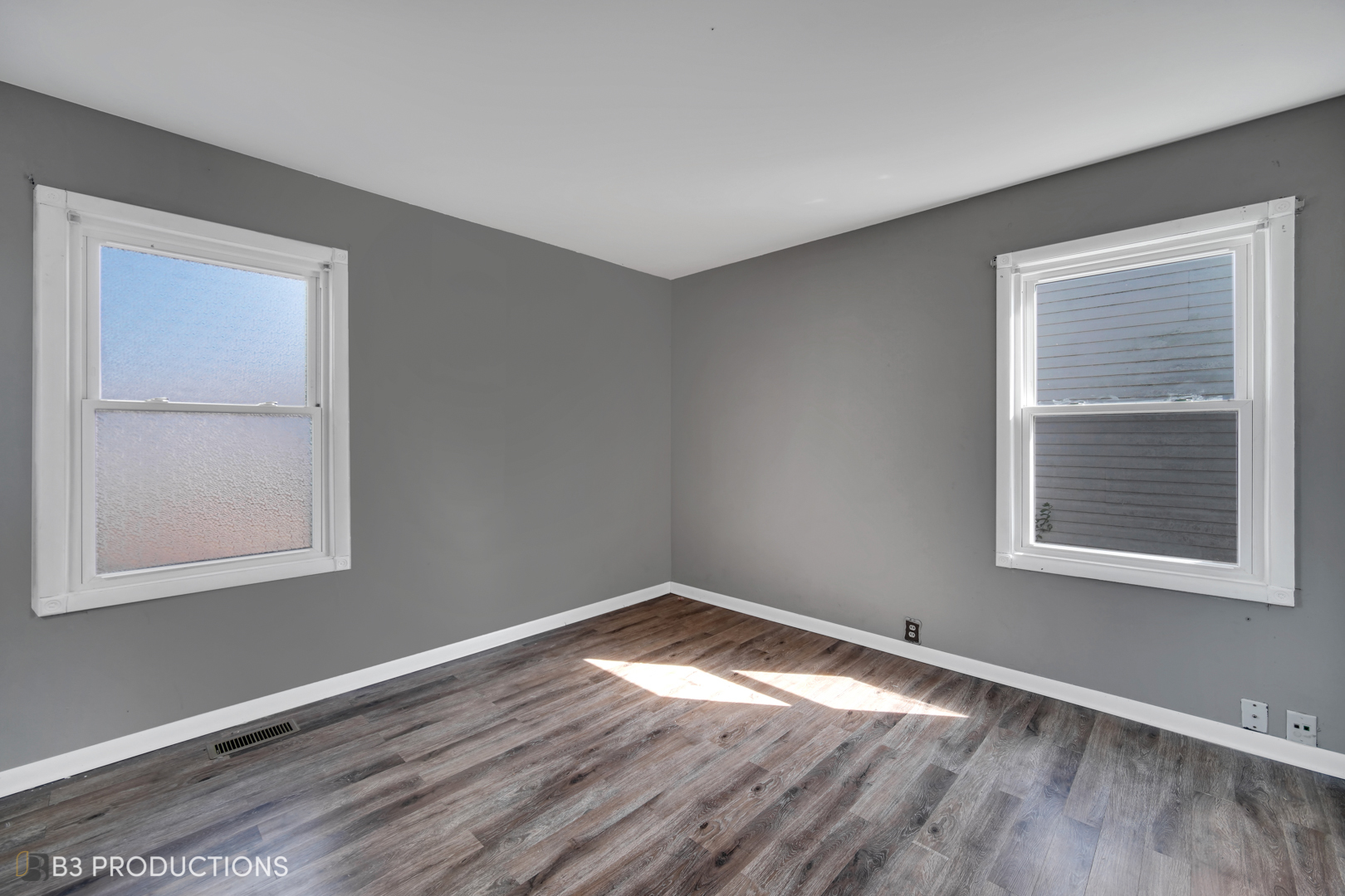 22 Arlington Drive Romeoville, IL 60446 - Photo 9 of 15 an empty room with wooden floor and windows