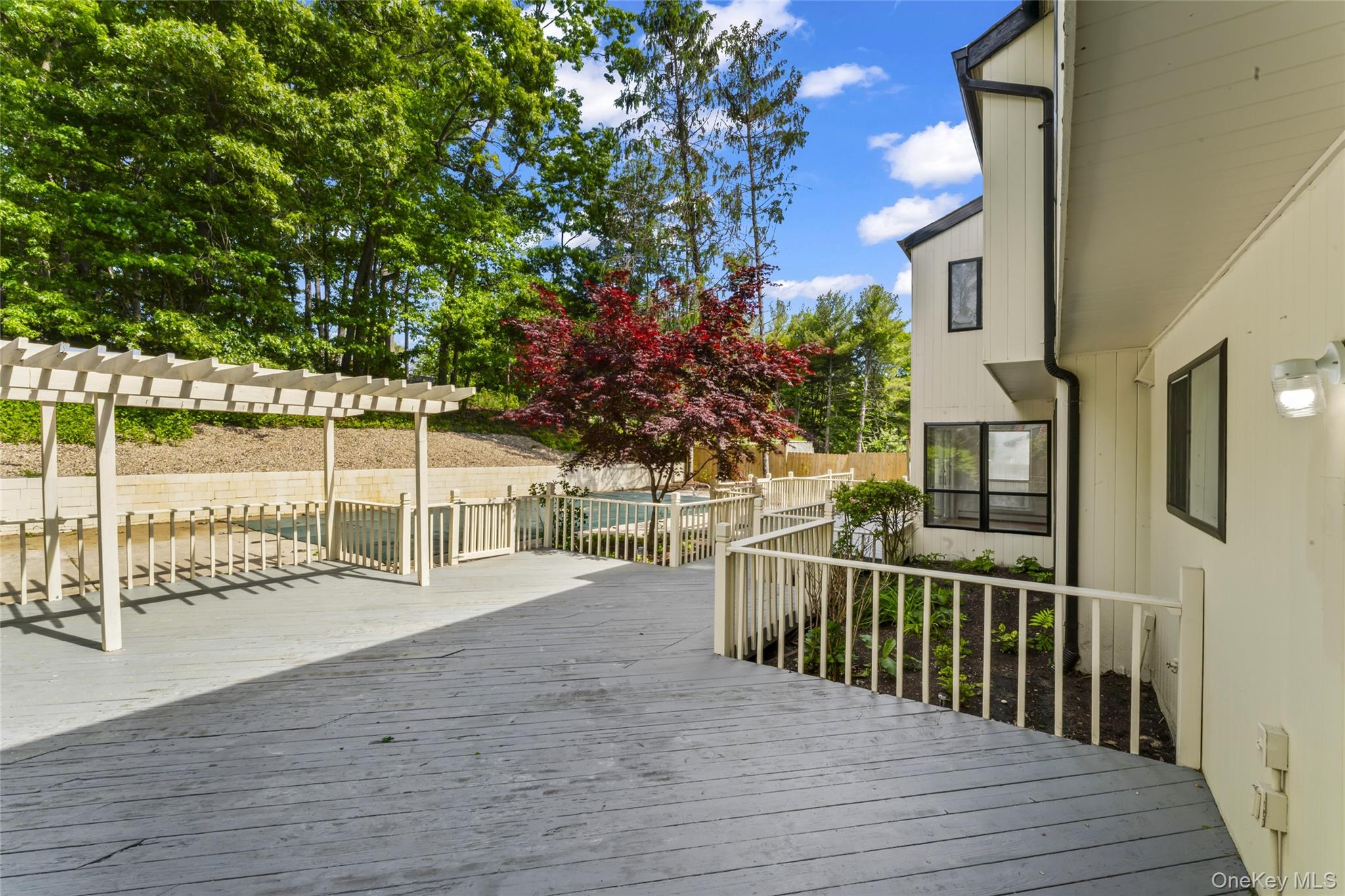 126 Bagatelle Road Melville, NY 11747 - Photo 41 of 50 a view of a house with a wooden deck