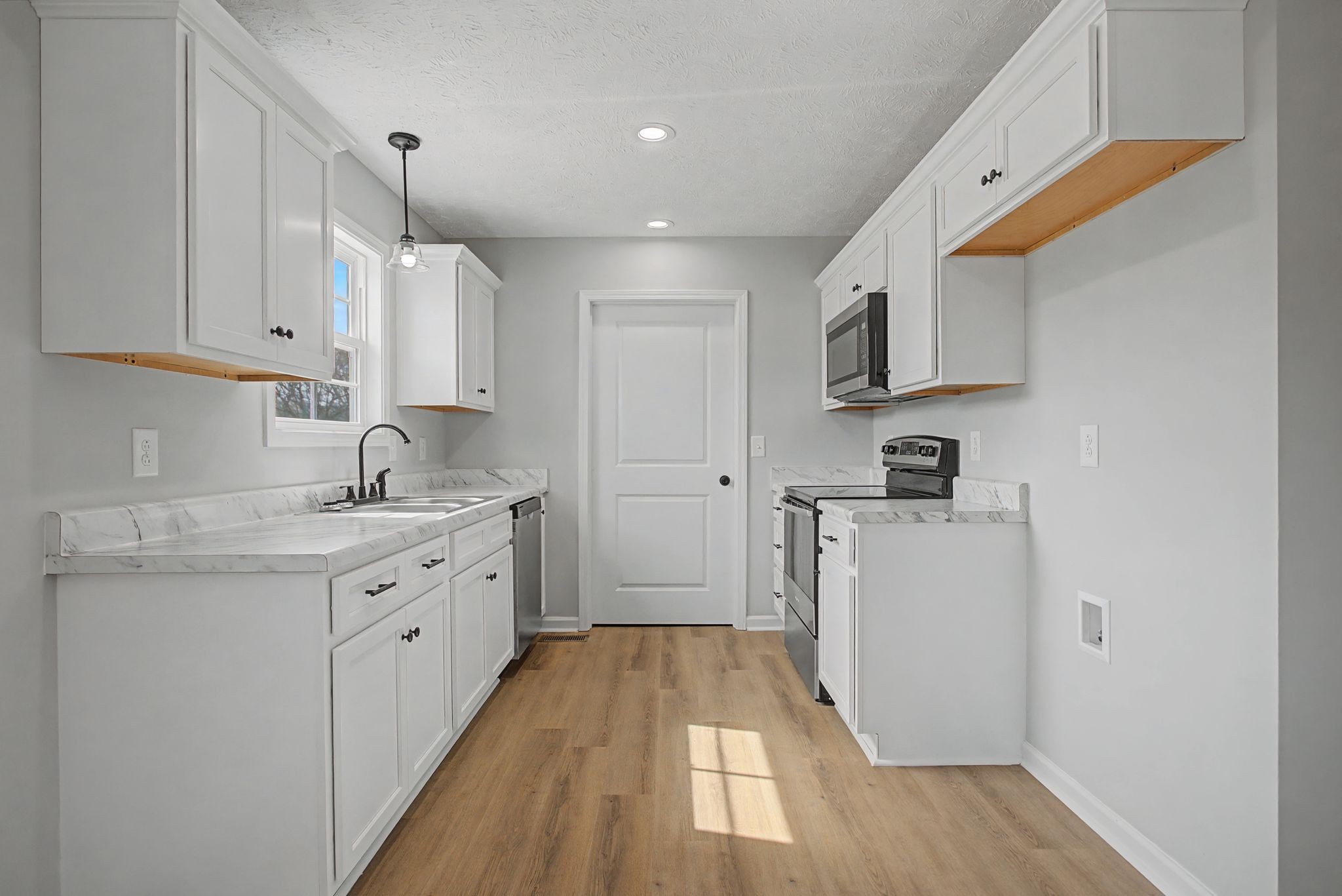 2333 Claude Fox Road Cornersville, TN 37047 - Photo 12 of 24 a kitchen with cabinets appliances a sink and a counter top space