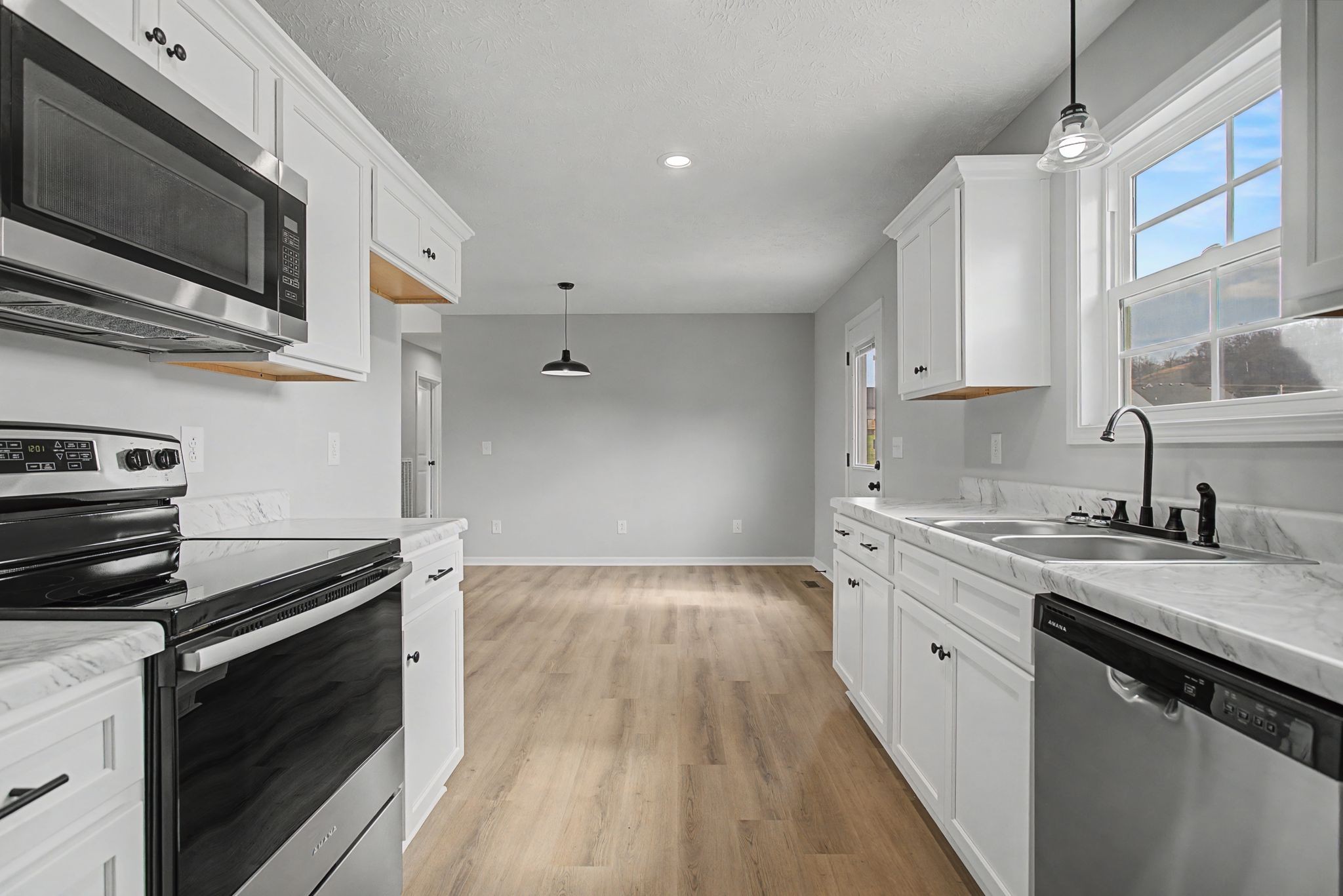 2333 Claude Fox Road Cornersville, TN 37047 - Photo 13 of 24 a kitchen with a sink stove and microwave