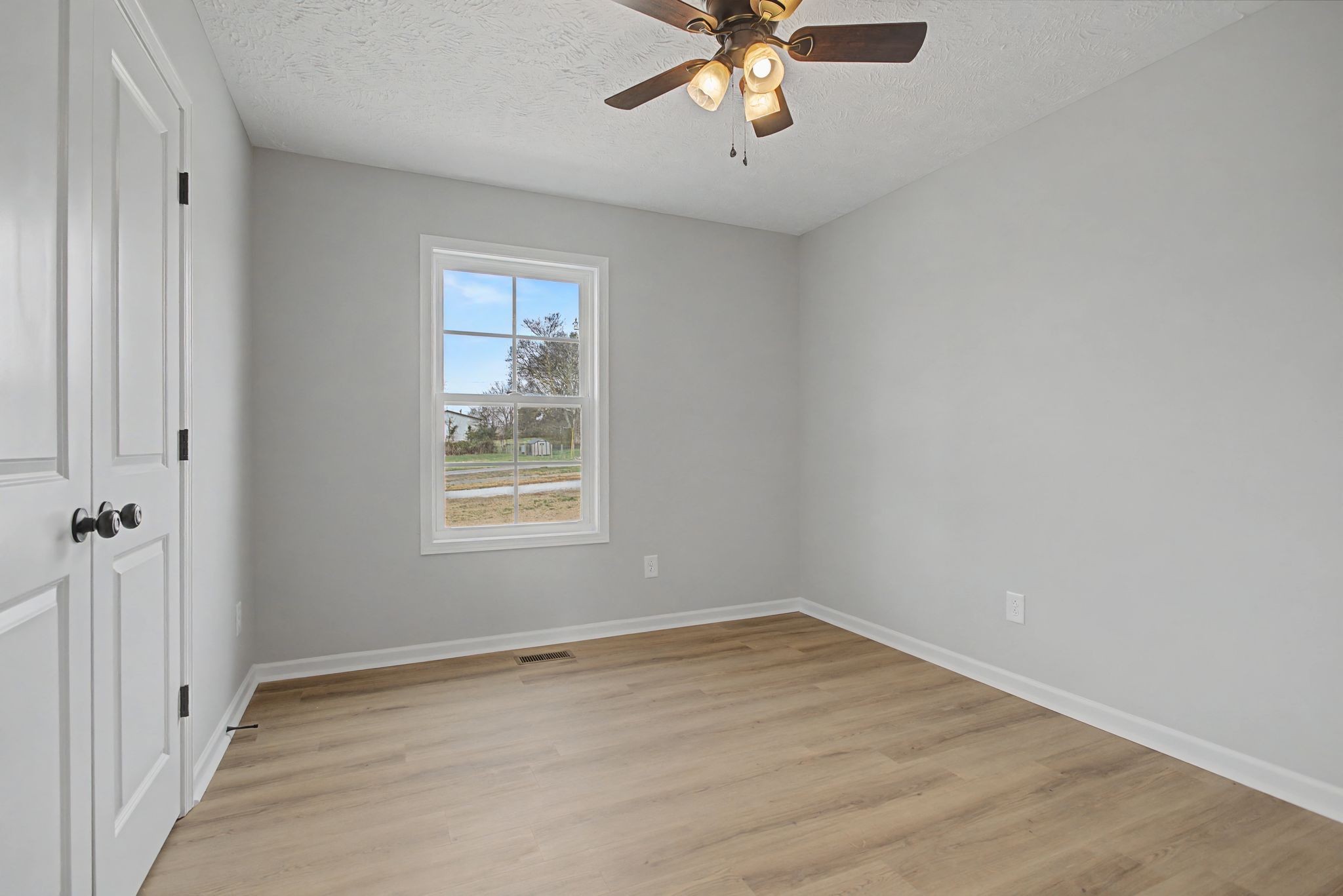 2333 Claude Fox Road Cornersville, TN 37047 - Photo 22 of 24 wooden floor in an empty room with a window