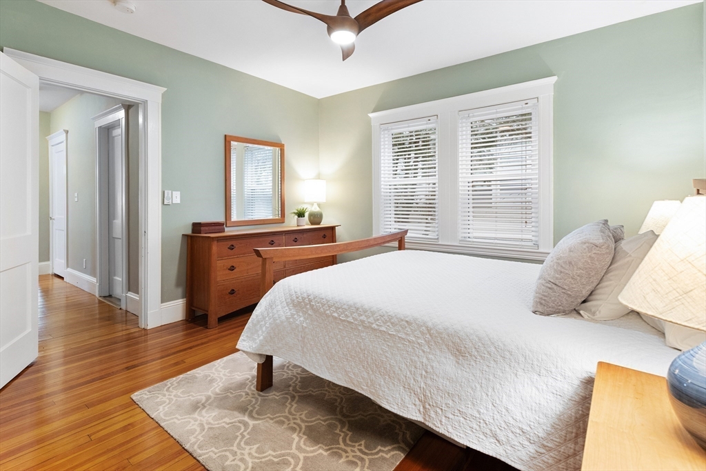 16 Orvis Road, Unit 1 Arlington, MA 02474 - Photo 17 of 31 a bedroom with a bed and wooden floor