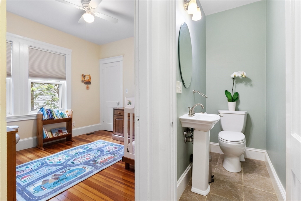 16 Orvis Road, Unit 1 Arlington, MA 02474 - Photo 21 of 31 a bathroom with a toilet a sink and a mirror