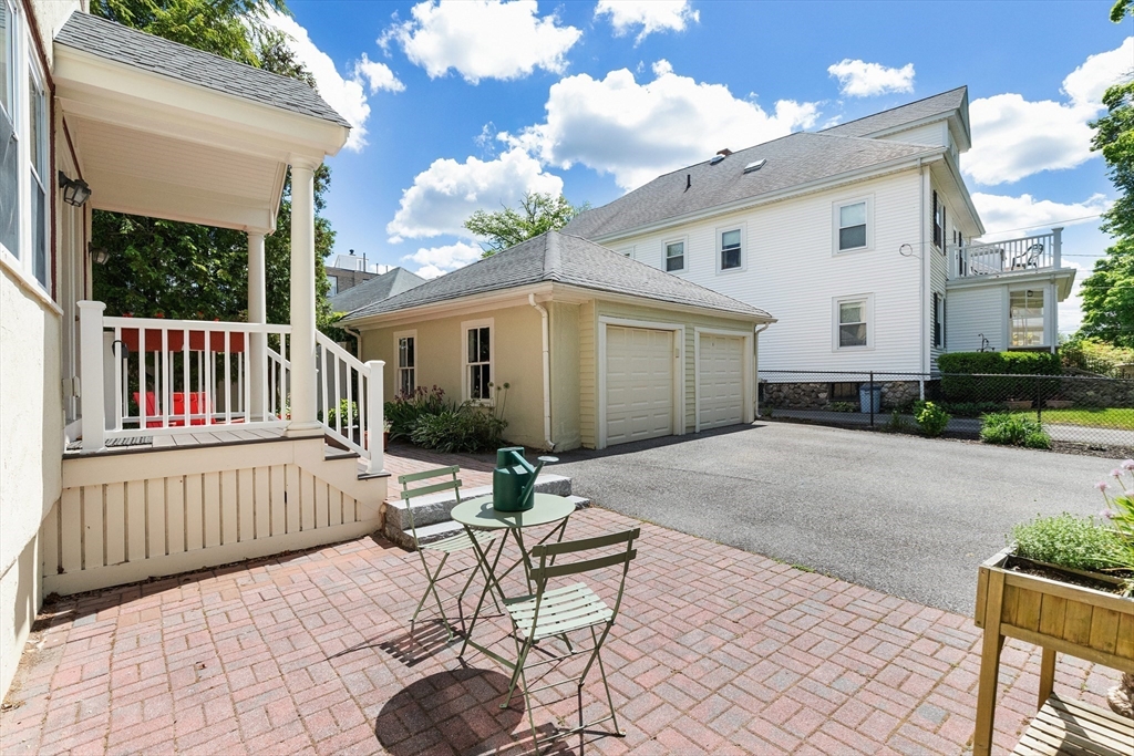 16 Orvis Road, Unit 1 Arlington, MA 02474 - Photo 25 of 31 a view of a patio with a table and chairs