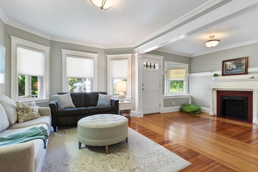 16 Orvis Road, Unit 1 Arlington, MA 02474 - Photo 4 of 31 a living room with furniture and a fireplace