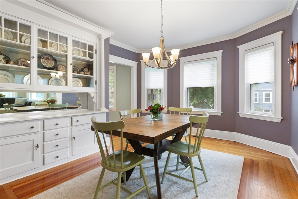 16 Orvis Road, Unit 1 Arlington, MA 02474 - Photo 9 of 31 a view of a dining room with furniture a chandelier and wooden floor