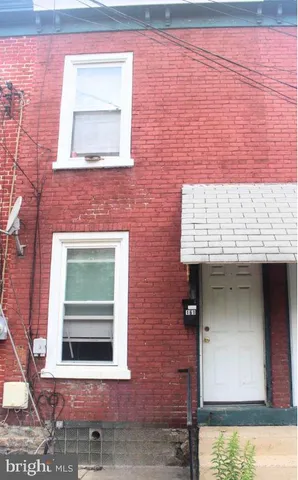 a front view of a building with a door and a window