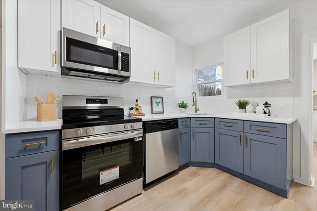 a kitchen with cabinets stainless steel appliances and cabinets