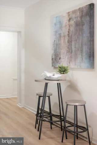 a view of a workspace with furniture and wooden floor