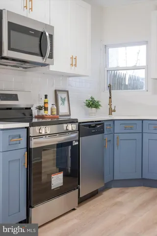 a kitchen with stainless steel appliances granite countertop a stove and a sink