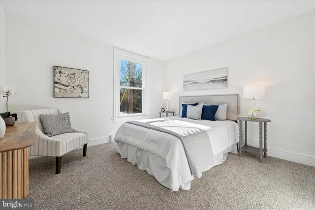 a bedroom with a bed and a couch