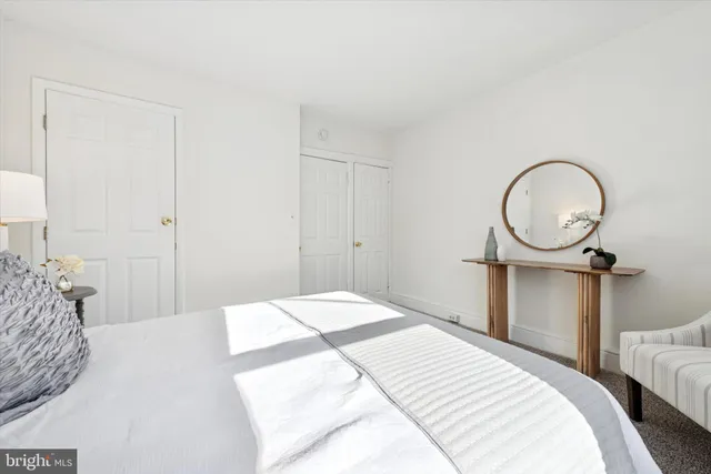 a bedroom with a bed and a mirror