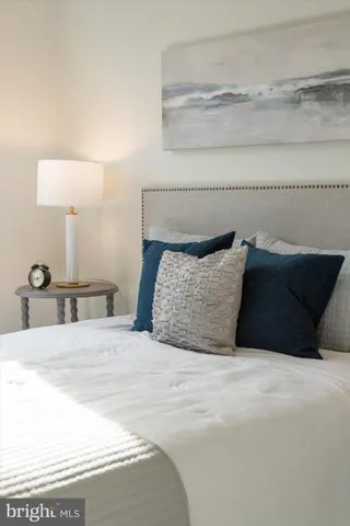 a large bed sitting in a bedroom and lamp