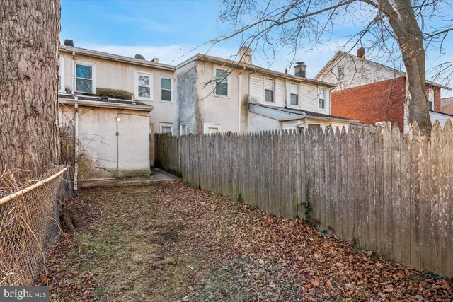 a view of a house with a wooden fence