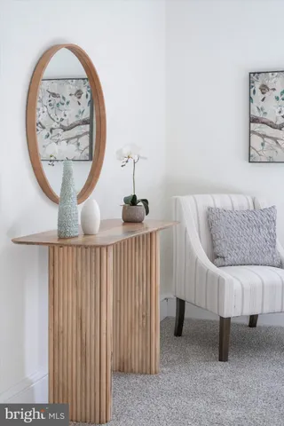 a view of a hallway with a furniture and paintings on the wall
