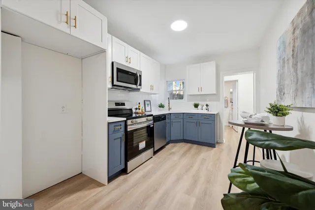 a kitchen with stainless steel appliances kitchen island wooden cabinets and granite counter tops