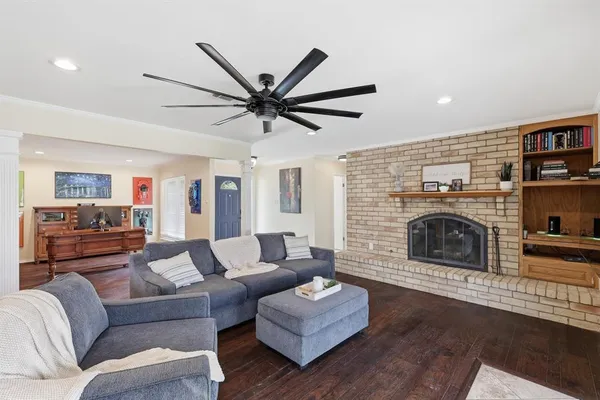 a living room with furniture a fireplace and a flat screen tv