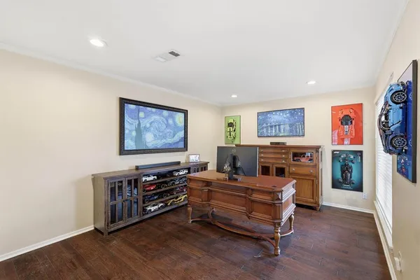 a bedroom with furniture and a flat screen tv