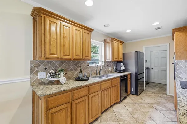 a kitchen with a sink stove and refrigerator