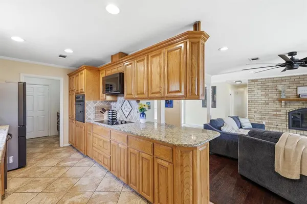 a kitchen with granite countertop a sink cabinets and window