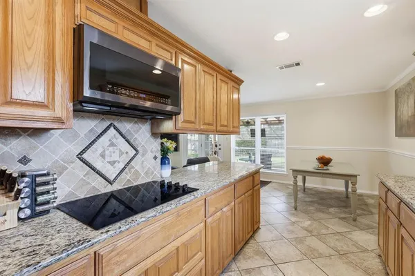 a kitchen with stainless steel appliances granite countertop a sink and a stove top oven