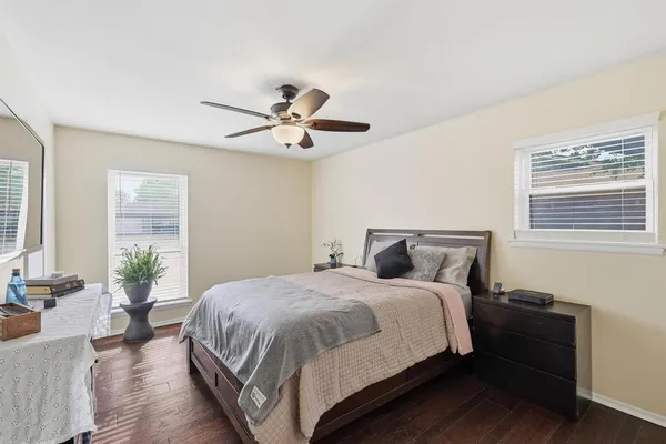 a bedroom with a large bed and a chandelier
