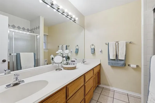 a bathroom with a double vanity sink and a mirror
