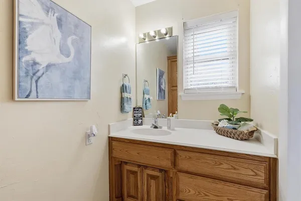 a bathroom with a double vanity sink and a mirror
