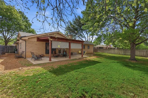 a front view of a house with patio and garden