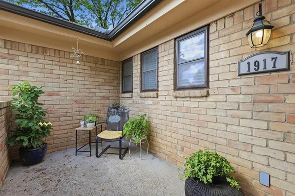 a brick building with a bench in patio