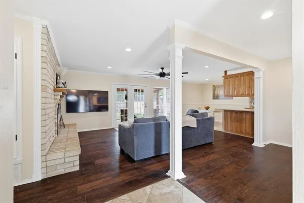 a living room with furniture and a wooden floor
