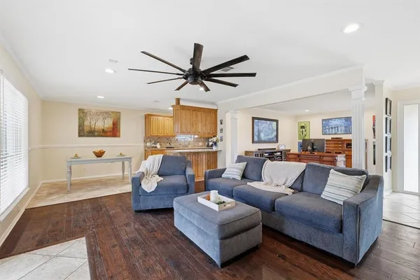 a living room with furniture or couches and a view of kitchen