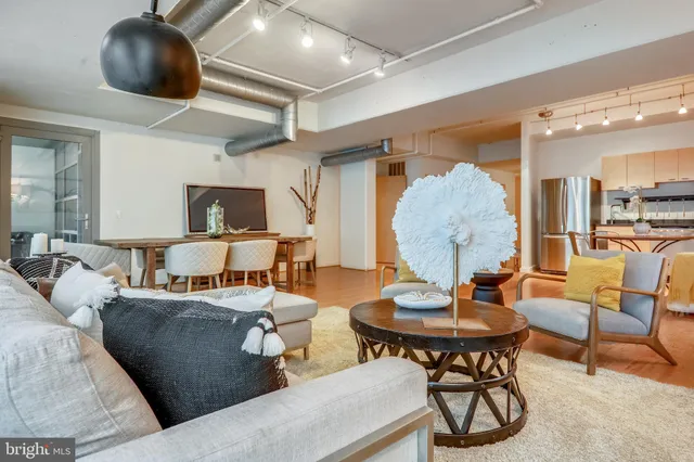 a living room with furniture and a chandelier