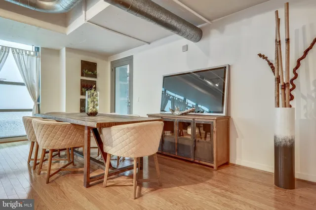 a view of a dining room with furniture window and wooden floor