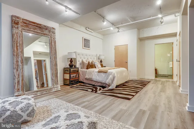 a bedroom with a bed and a mirror