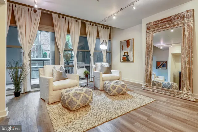 a living room with furniture and a large window