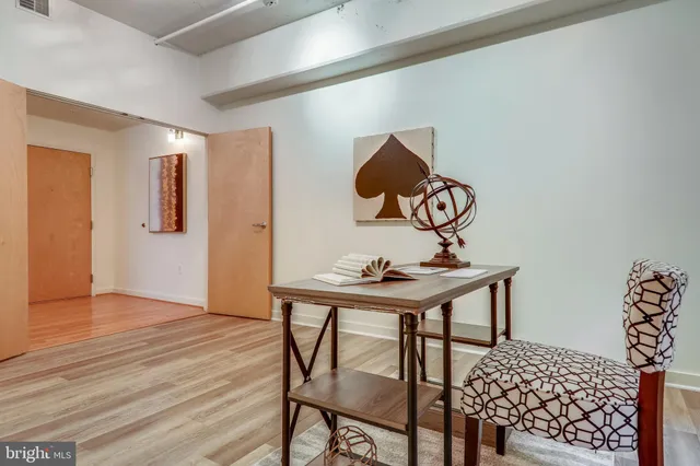 a view of a workspace room with wooden floor