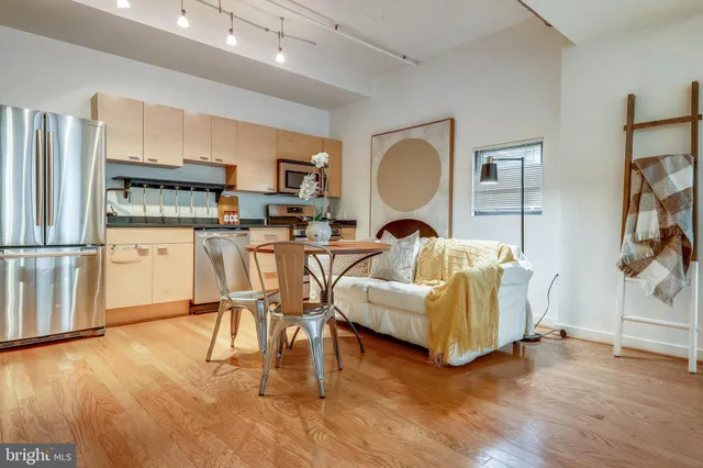 a living room with furniture a wooden floor and a fireplace
