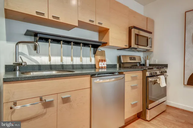 a kitchen with stainless steel appliances granite countertop a stove and a sink