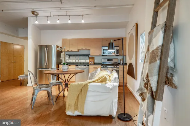 a room with gym equipment and wooden floor