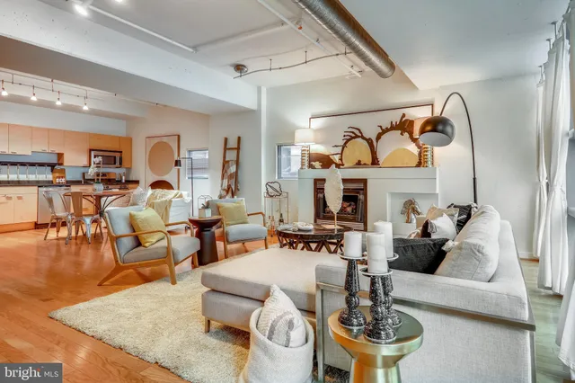 a living room with fireplace furniture and a large window