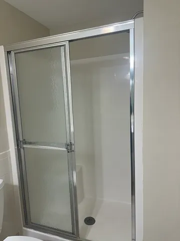 a bathroom with a glass shower door