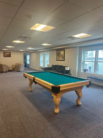 a room with pool tables and windows