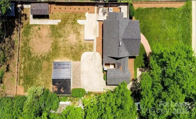 an aerial view of residential house with outdoor space and trees