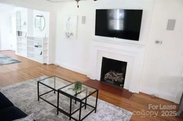a living room with a fireplace a flat screen tv and a fireplace
