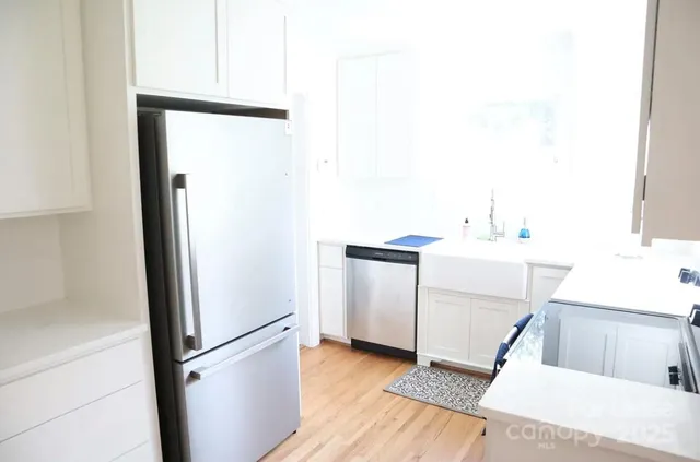 a utility room with cabinets washer and dryer
