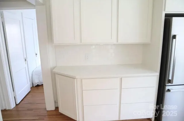a view of cabinets with wooden floor