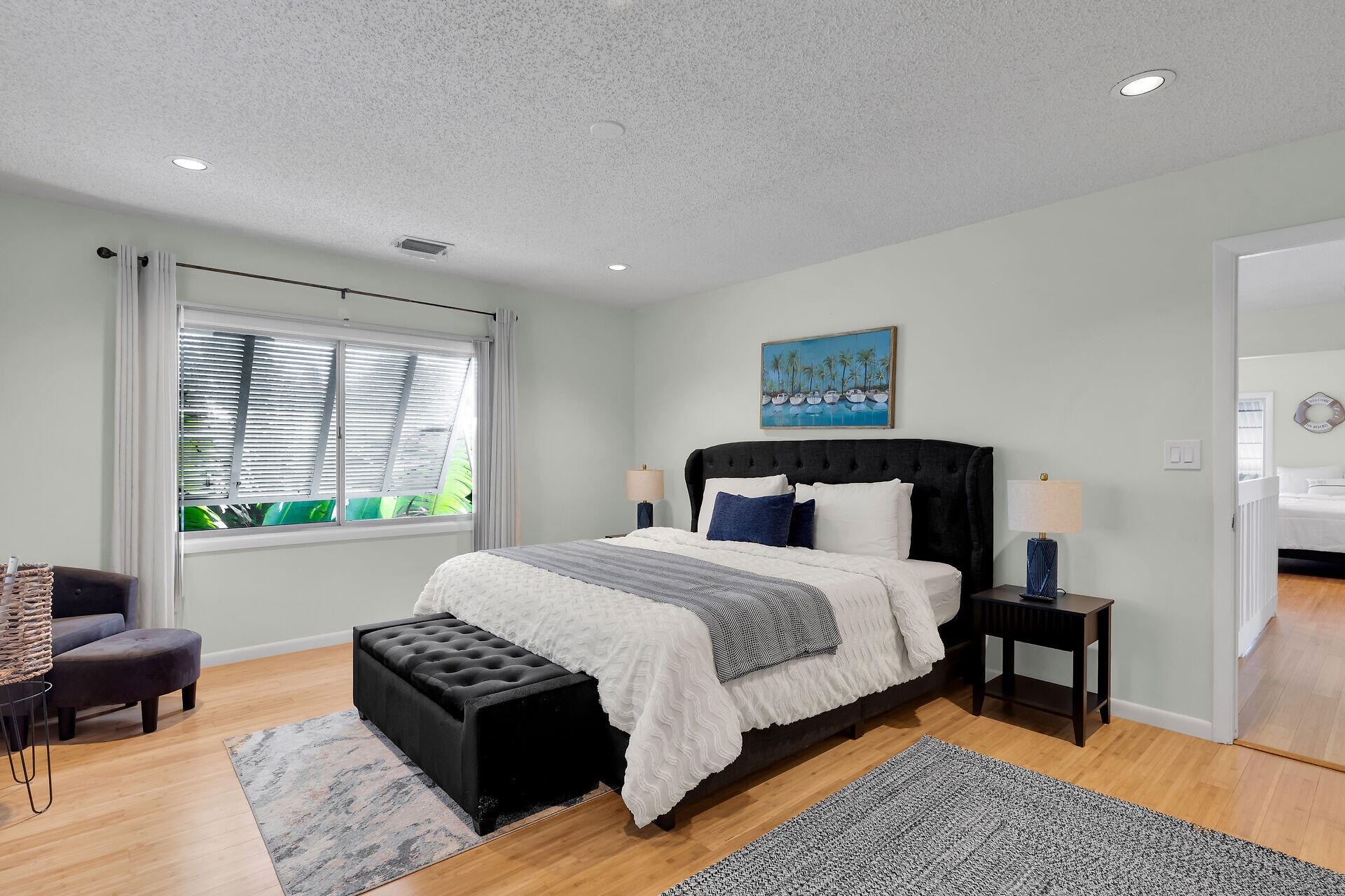 1519 Johnson Street Key West, FL 33040 - Photo 31 of 47 a bedroom with a bed wooden floor and a large window