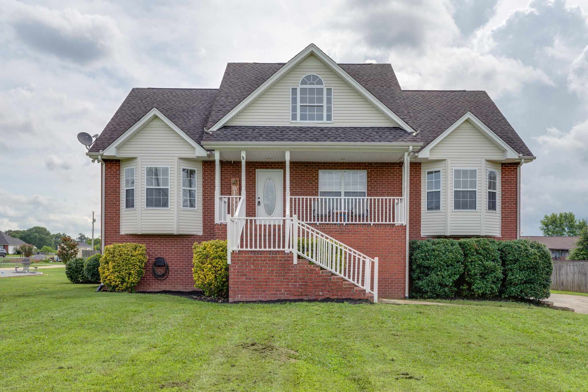 a front view of a house with a garden