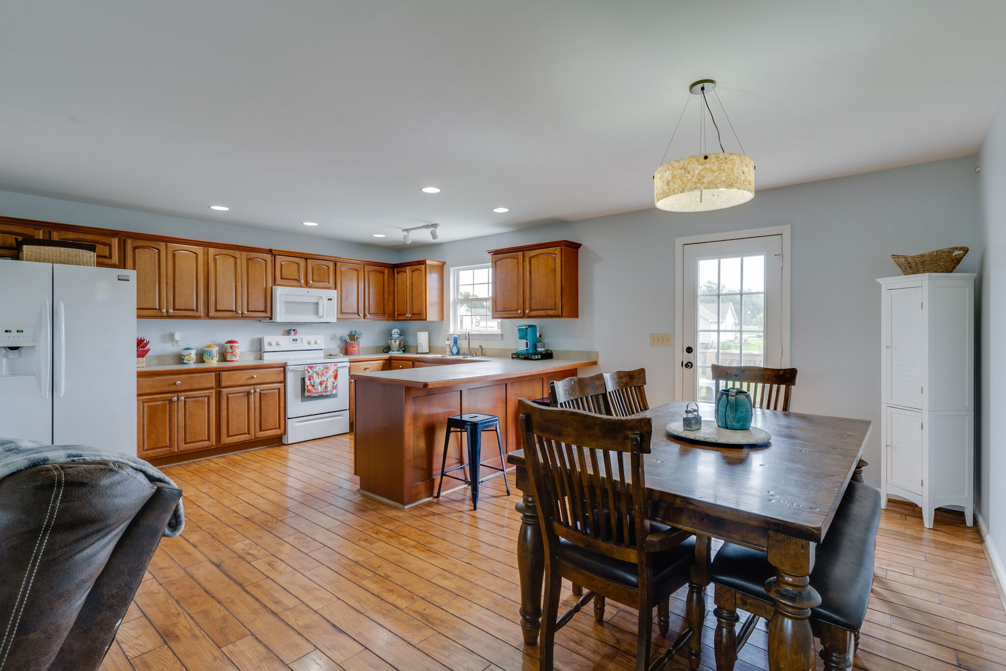 5259 East Robertson Road Cross Plains, TN 37049 - Photo 6 of 28 a open dining room with stainless steel appliances kitchen island granite countertop a dining table chairs and a kitchen view